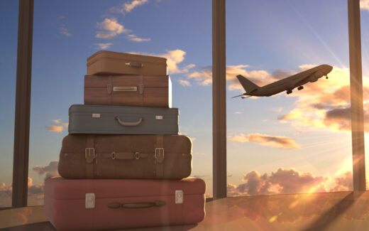 suitcases and airplane in background